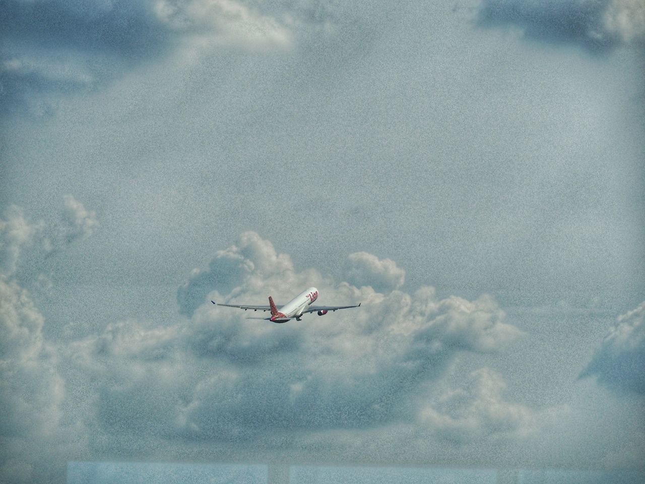 LOW ANGLE VIEW OF AIRPLANE IN SKY