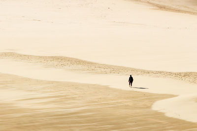 Woman walking on sand at beach