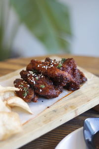 Close-up of korean spicy wings in plate on table