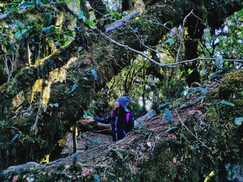 Woman standing in forest