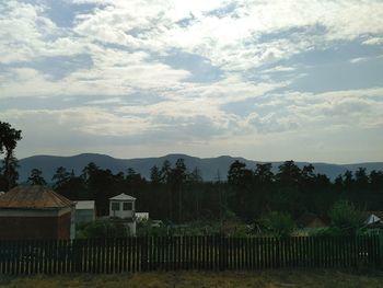 Scenic view of mountains against cloudy sky