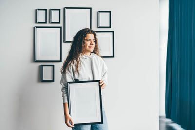 Portrait of young woman using mobile phone