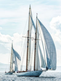 Sailboat sailing on sea against sky