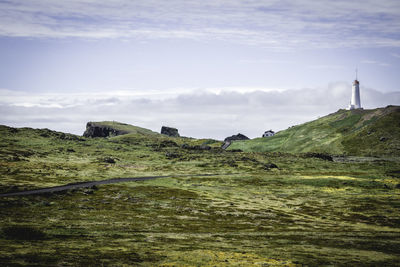 Scenic view of landscape against cloudy sky