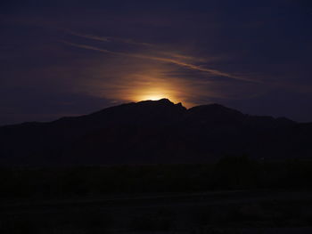 Scenic view of silhouette mountain against sky at sunset