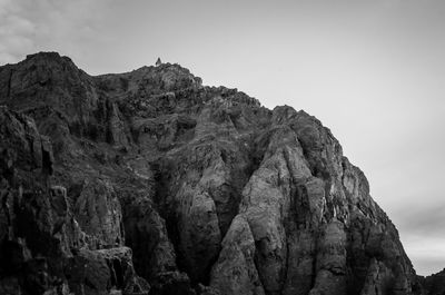 Low angle view of rock formation against sky