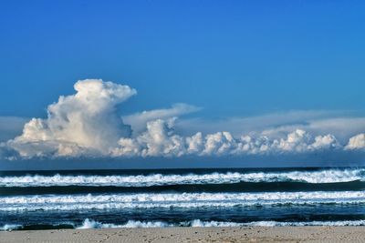 Scenic view of sea against blue sky