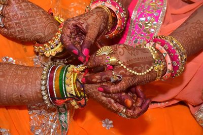 Midsection of women wearing jewelries in wedding ceremony