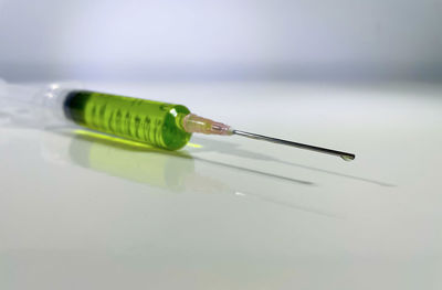 Close-up of colored pencils on table against white background