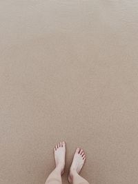 Low section of woman standing on beach