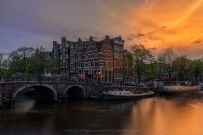 View of bridge over river against cloudy sky