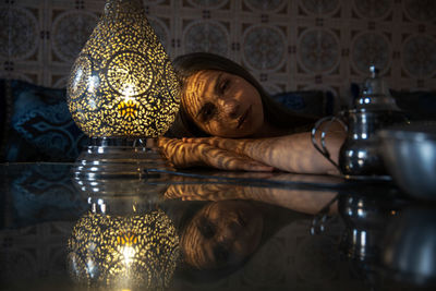 Portrait of woman sitting on table