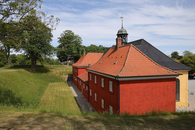 Houses on field against sky