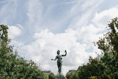 Low angle view of statue against sky