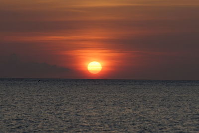 Scenic view of sea against romantic sky at sunset