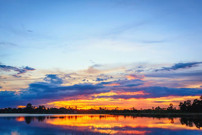 Scenic view of lake against romantic sky at sunset