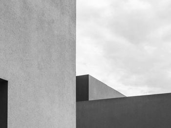 Low angle view of building against cloudy sky