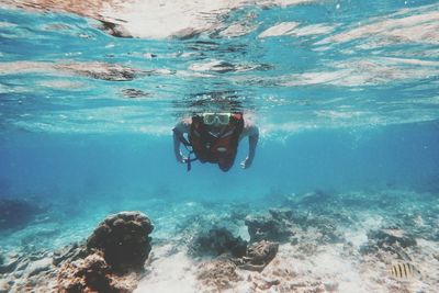 Portrait of young woman swimming in sea