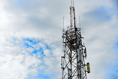 Low angle view of communications tower against sky