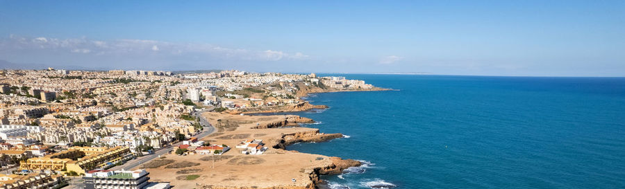 High angle view of sea and buildings against sky