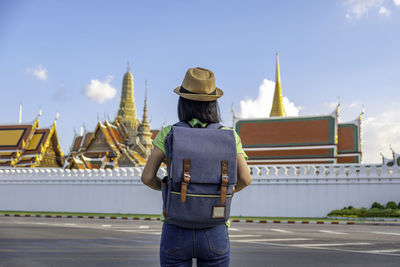 Rear view of man standing outside temple