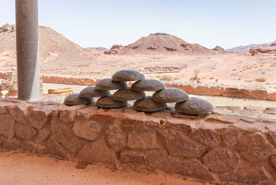Rocks in desert against clear sky