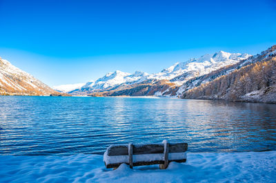 Engadine, switzerland, sils maria lake, the village of isola and the snowy landscape.