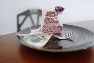 Close-up of cake slice served in plate on table