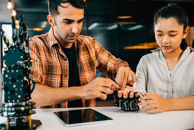 Portrait of young man playing chess at home