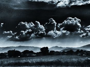 Scenic view of landscape against cloudy sky