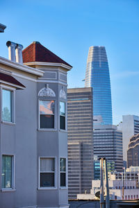 Low angle view of modern buildings against clear blue sky