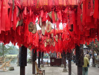 Low angle view of red japanese fortune ribbons hanging at shrine