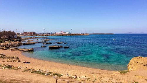 Scenic view of sea against clear blue sky