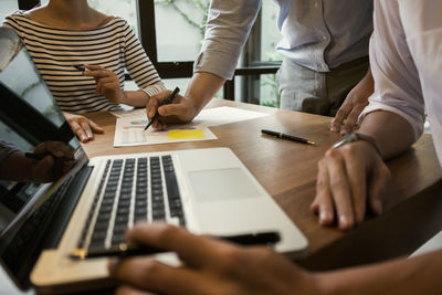 Low section of people working on table