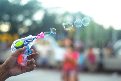 Cropped image of person playing with squirt gun