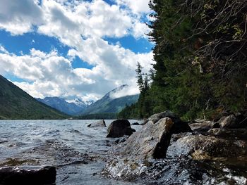 Scenic view of waterfall against sky