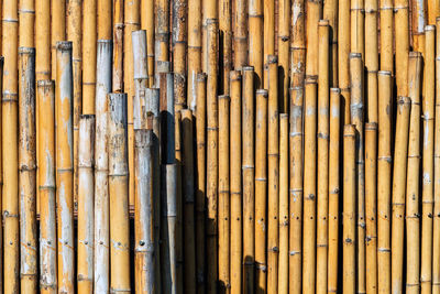 Old brown tone bamboo simple wall or bamboo fence texture background for  design vintage tone. 