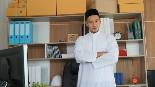 Portrait of female doctor standing in office