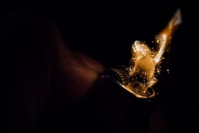 Close-up of human hand against black background