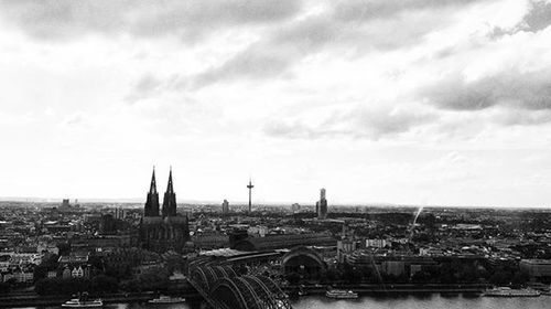 Cityscape against cloudy sky