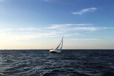 Sailboat in sea against sky