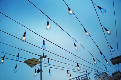 Low angle view of birds perching against sky