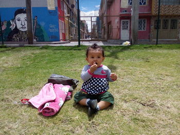 Cute girl sitting on grass