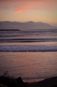 Scenic view of beach against sky during sunset