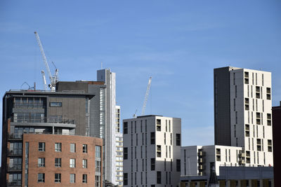 Low angle view of buildings against blue sky