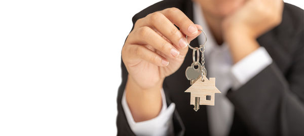 Close-up of man holding hands over white background