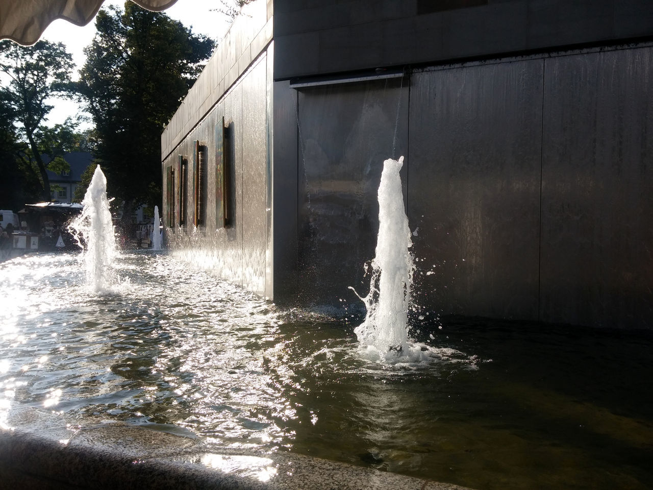 WATER FOUNTAIN IN FRONT OF WATERFALL