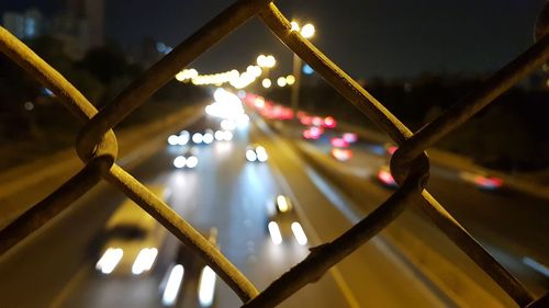 Defocused image of illuminated street at night