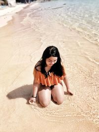 Woman sitting on beach