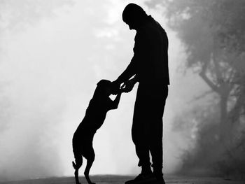 Low angle view of man standing against sky